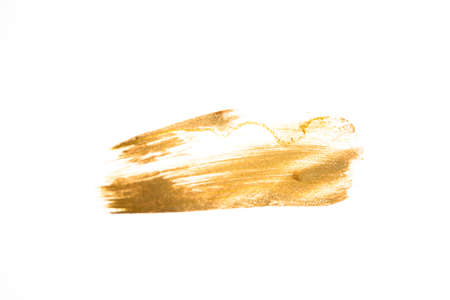 Gold acrylic brushstroke isolated on a white background.の写真素材