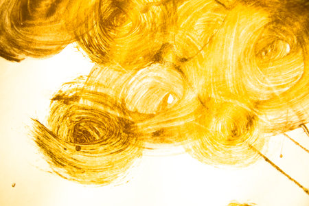 Gold acrylic brushstroke isolated on a white background.