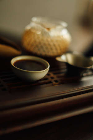 tea ceremony, tea brewing on a brown tea board, dark abstract tea backgroundの写真素材