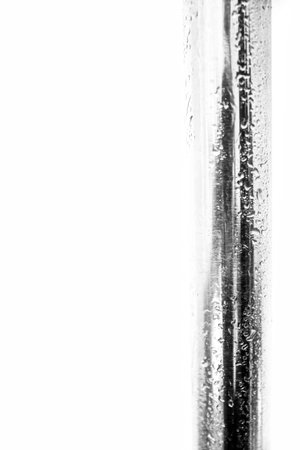 metal pipe in the rain, water drops on the iron surfaceの写真素材