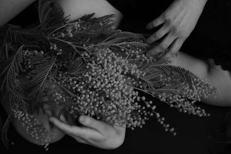 Black and white art fashion surrealistic portrait of beautiful woman with plants and flowersの写真素材