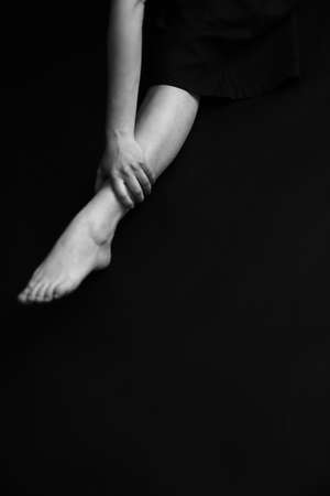 women's legs close-up, black and white photo of body details, elegant and sensual fingersの写真素材