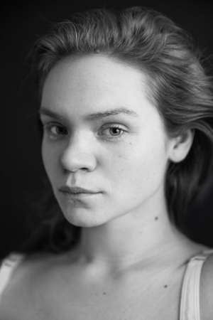 simple fashion portrait of a beautiful woman, fuzzy film black and white photoの写真素材