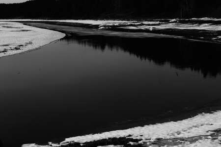 black and white pond in winter, film vintage photoの写真素材