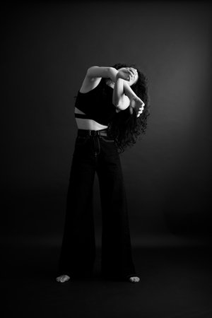 women's hands on a dark background, emotions and closed poseの写真素材