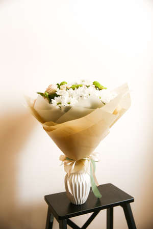 bouquet of fresh flowers on a neutral background, the concept of March 8 and mother's Dayの写真素材