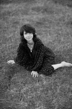 black and white full-length portrait, a girl posing in nature. Art black-and-white frames, fuzzy and noisy, blurring and defocusの写真素材