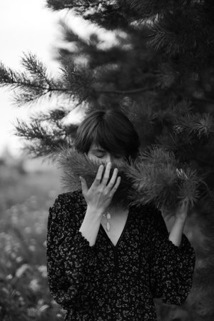 hand and branch of a plant, black and white aesthetics, beautiful blurred soft focusの写真素材
