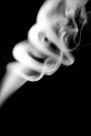 smoke clouds on a black background, white patterns from vape and cigarettes, art photos, soft focus and texture blurringの写真素材