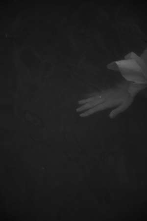 body details, female palms on a dark background, a beautiful fuzzy and unfocused image of hands and fingersの写真素材