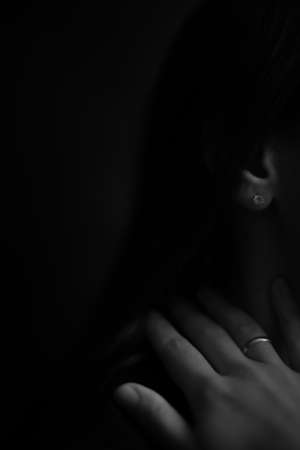 body details, female palms on a dark background, a beautiful fuzzy and unfocused image of hands and fingersの写真素材