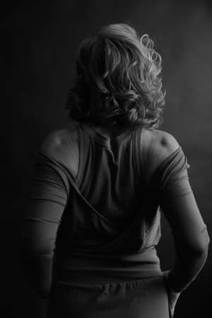 black and white photo shoot, dramatic full-length portrait of a woman, human movements on camera, unfocused and noisy portrait on an old film cameraの写真素材
