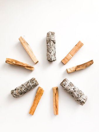 Bundle of dry white sage close-up. Product for purification, meditation and healing. Set of incense for fumigation of premises. Branches of white sage on a white background. View from above.の写真素材
