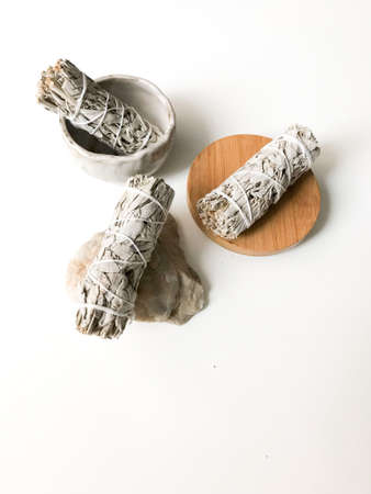 bunches of white California sage on a white background, minimalism and a place for text. sacred incense, aromatherapy and meditationの写真素材
