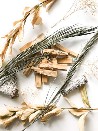 beautiful layout of palo santo and white sage, aromatherapy and incense on a white background. Place for text, religious minimalistic backgroundの写真素材