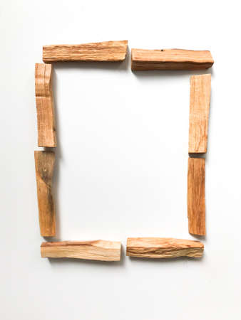 a set of palo santo sticks, a square frame, a place for text. aroma background on a white background with light blurredの写真素材