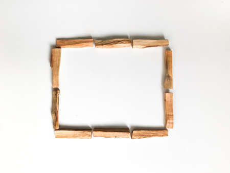 a set of palo santo sticks, a square frame, a place for text. aroma background on a white background with light blurredの写真素材