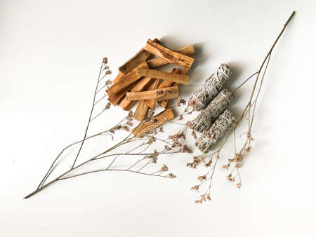 beautiful layout of palo santo and white sage, aromatherapy and incense on a white background. Place for text, religious minimalistic backgroundの写真素材