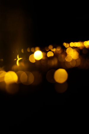 Abstract orange and gold dark background with glowing turquoise particles.