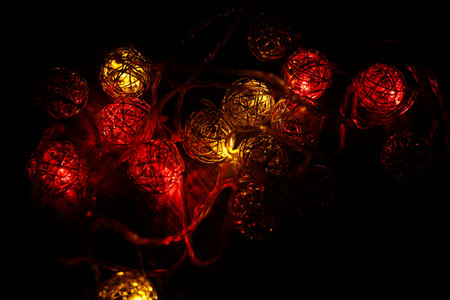 A garland of round balls glows softly in the night