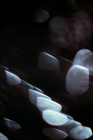 Abstract dark background with glowing blue particles. beautiful blur and bokeh