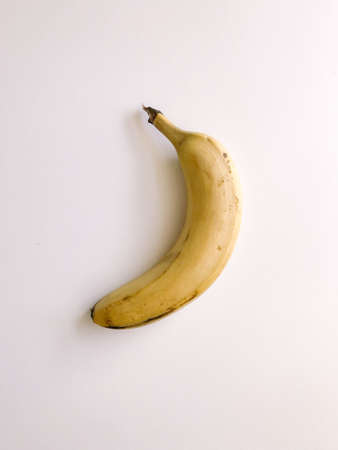 Very ripe bananas on a white background, a pattern of bananas with brown spotsの写真素材