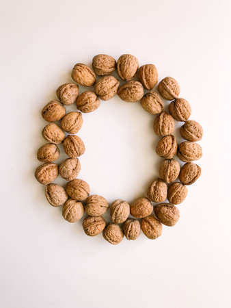 A handful of walnuts in a shell close-up, a set of walnut shells on a white backgroundの写真素材
