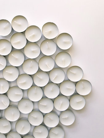 Set of white tea round candles, close-up on a white background, place for text