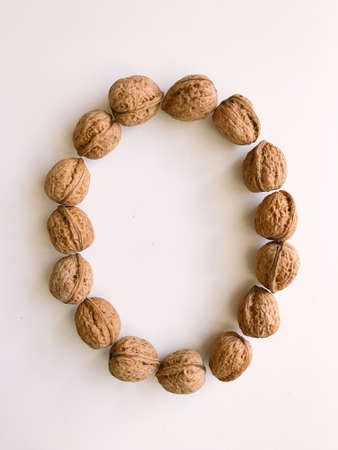 A handful of walnuts in a shell close-up, a set of walnut shells on a white backgroundの写真素材