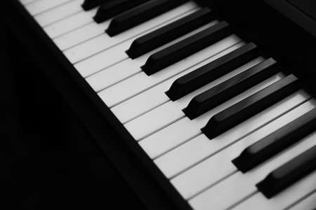 Background music, black and white piano keys in the darkの写真素材