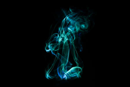 Green smoke pattern, beautiful puffs of smoke from cigarettes and hookah in the darkの写真素材