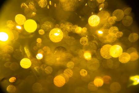abstract orange-yellow background, glare and blur, surface ripples, radiance and sparks