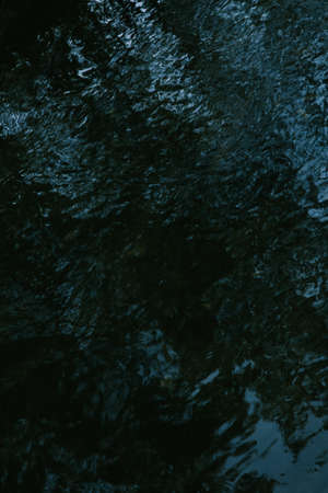 Abstract background of dark water surface with ripples. Texture of dark water surface.の写真素材