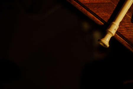 Close-up of a wooden pipe on a black background with copy spaceの写真素材