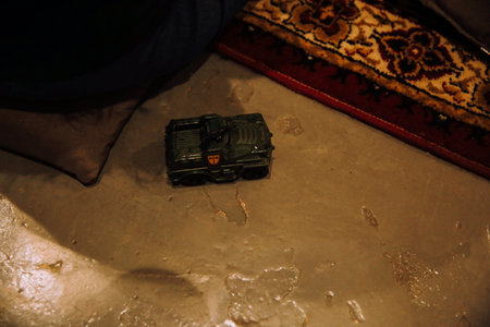 A closeup shot of a toy car on the ground with a blurred background
