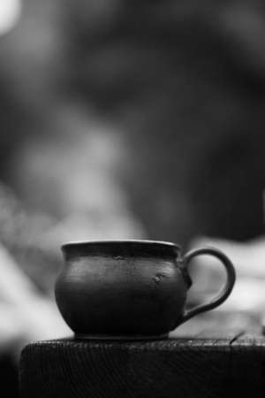 Cup of coffee on the wooden table. Black and white photo.の写真素材