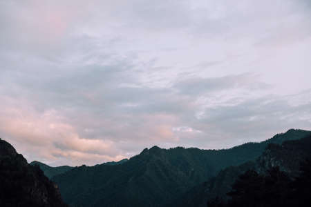 Mountain landscape with clouds at sunset. Silhouette of the mountains.の写真素材
