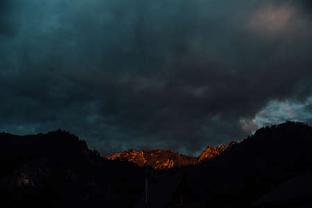 Dramatic dark sky over the mountain village. High quality photoの写真素材