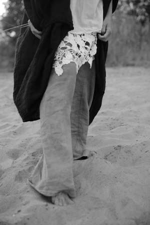Body details, women's legs close-up, the beauty of the female body. Frame with soft focus and the effect of film vintage photographyの写真素材