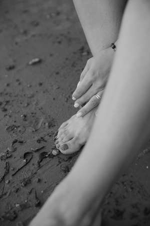 Delicate female hand close-up, beautiful body details out of focusの写真素材