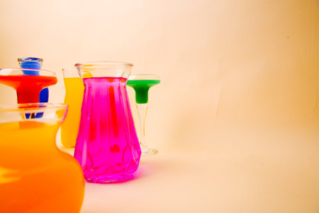 Glass vases and glasses with multicolored water, art background for drinksの写真素材