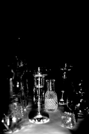 Vintage glass bottles on the table. Black and white photo.