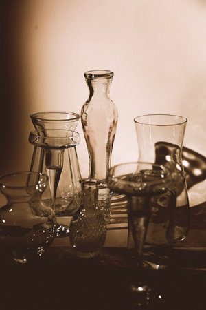 still life with glassware and decanter in sepia toneの写真素材