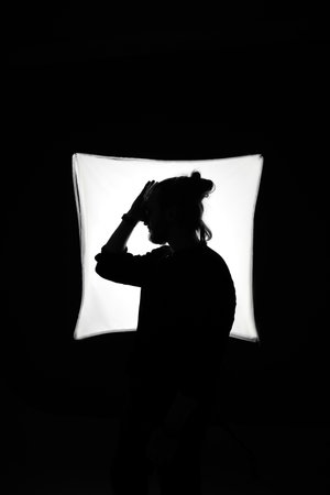 silhouette of a girl in the studio on a black backgroundの写真素材