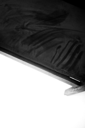 Black and white photo of a chair on a white background with a shadowの写真素材