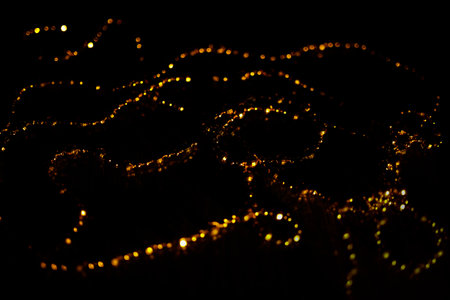 abstract background with bokeh defocused lights on black backgroundの写真素材