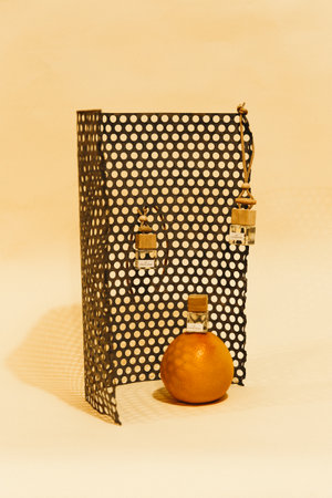perfume bottle with tangerine on white background, still lifeの写真素材