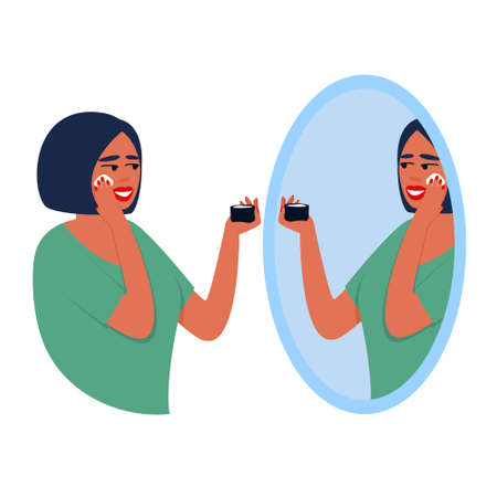 Woman applies cream to her face while looking in the mirror. Illustration on isolated background. The woman admires herself in the mirror. Flat vector illustration.のイラスト素材