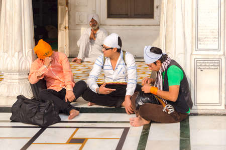 Amritsar, India - November 21, 2011: The Sikh pilgrims in the Golden Temple complex. Amritsar, Punjab, India.のeditorial素材