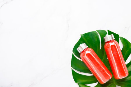 Fitness, healthy nutrition diet concept. Fresh cool watermelon juice in a glass jar and tropical...
